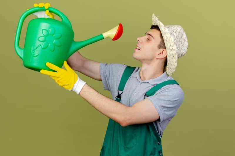 a man handling a water sprinkler