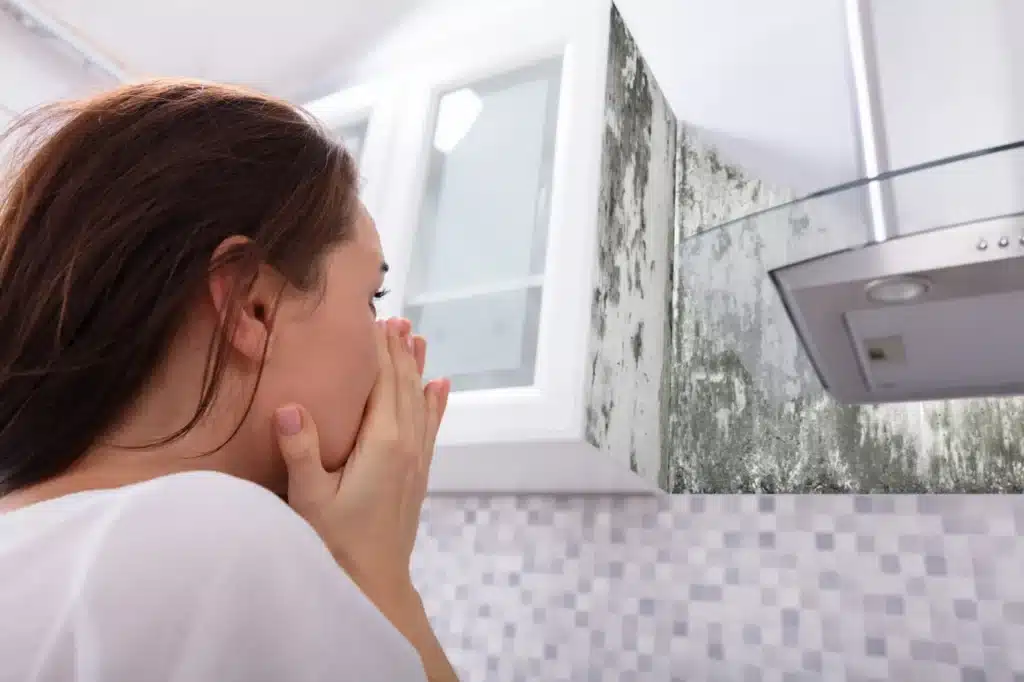 a girl in the bathroom seeing a mold 