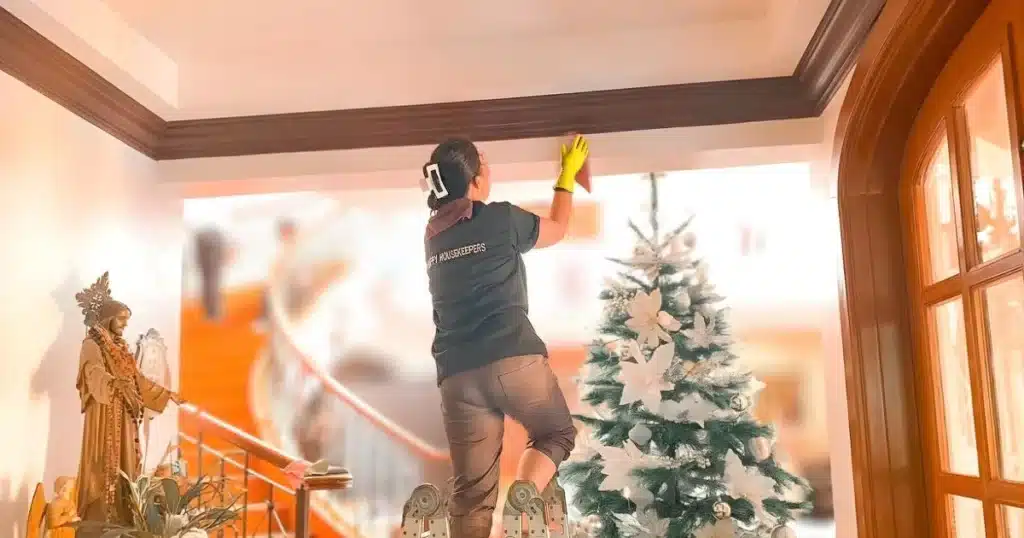 a housekeeping cleaning the ceiling